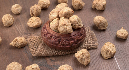 Raw soya chunks on dark background. Healthy, nutritious soybean meat, chunks isolated.Vegan food concept.
