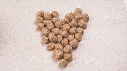 Raw soya chunks on dark background. Healthy, nutritious soybean meat, chunks isolated.Vegan food concept.
