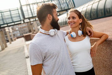 Portrait of happy fit sporty couple exercising and enjoying healthy lifestyle. People sport concept