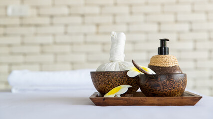 Closeup shot of Thai massaging stuffs herbal towel compress ball, coconut oil, perfume, cosmetics...