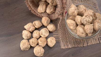 Raw soya chunks on dark background. Healthy, nutritious soybean meat, chunks isolated.Vegan food concept.