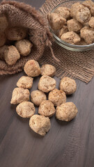 Raw soya chunks on dark background. Healthy, nutritious soybean meat, chunks isolated.Vegan food concept.