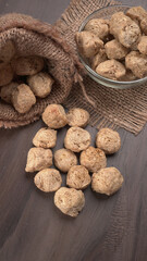 Raw soya chunks on dark background. Healthy, nutritious soybean meat, chunks isolated.Vegan food concept.