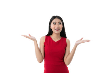 Happy beautiful young Asian woman in business red dress is smiling, looking up while showing or holding something on two hands palm with blank copy space, isolated white background with clipping path. - 478270825