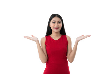 Happy beautiful young Asian woman in casual red dress is smiling, looking camera while showing, holding something on two hands palm with blank copy space, isolated white background with clipping path.