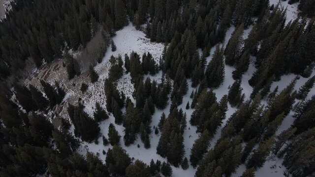 Aerial tilt up the valley between Mt. Lincoln and North Star Mountain with a frozen Montgomery Reservoir below. Filmed in the Rocky Mountains of Colorado at Hoosier pass between Breckenridge and Alma.