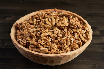 Wooden bowl with walnuts