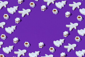 Christmas pattern made of different cookies decoration against purple background. Minimal Holiday food concept. Creative New Year's background. Copy Space.