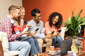 Young friends video calling together with their smartphones - Community concept with multicultural and multiethnic friends having fun vlogging live - Diversity and technology concept