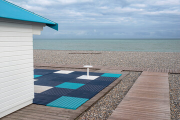Beach hut and pebble beach in the town of Dieppe in Normandy - obrazy, fototapety, plakaty