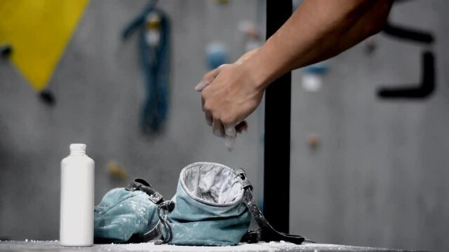 male hand using magnesium powder before climbing practice