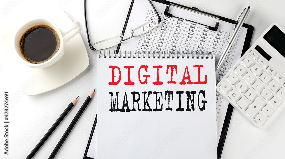 Poster digital marketing text on the paper with calculator, notepad, coffee ,pen with graph
