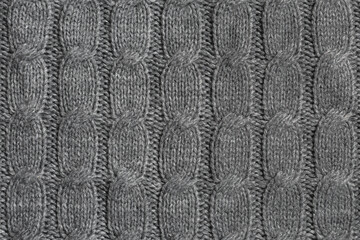 Gray fabric knitted from threads with a braided pigtail pattern