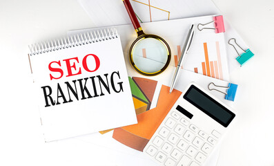 White notepad text SEO RANKING with diagram,chart,calculator on the white background