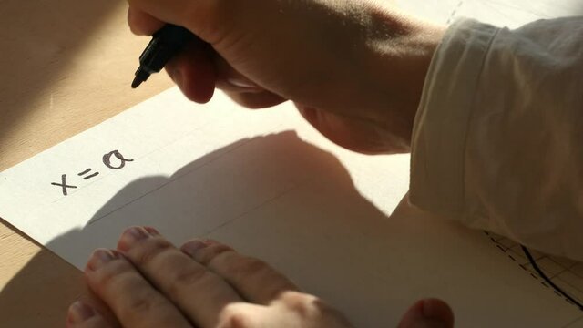 Mathematician writes a parametric equations for ellipse on a paper. Date of shooting day 23 November 2021 year. This video was filmed in Russia.