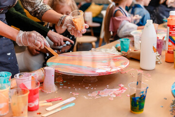 On the table is a painting in the technique of 