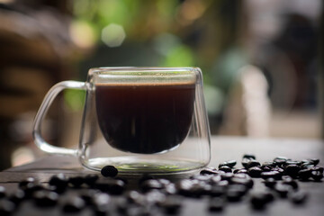 A cup of Indonesian black coffee with blur background, selected focus