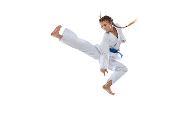Dynamic portrait of young girl, teen, taekwondo athlete jumping isolated over white background. Concept of sport, education, skills © master1305