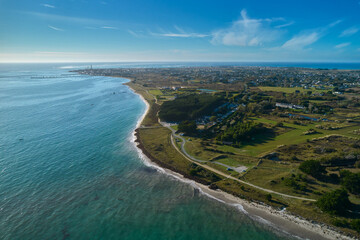 Aerial view of a small beach in france. Green plant and camping place. Further away a town. France, Brittany, Penmarch.