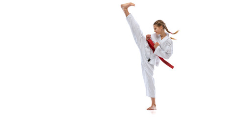 Flyer. Portrait of young girl, teen, taekwondo athlete practicing alone isolated over white...