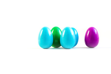 five different colored easter eggs on white surface