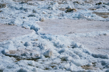 Fototapeta na wymiar Melting ice on the river in spring. Ice drift time. Natural structure.