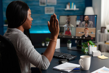 Person talking to workmates on video call to do teamwork project. Woman doing business meeting on...