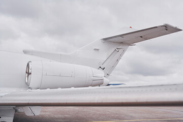 White plane. Turboprop aircraft parked on the runway at daytime