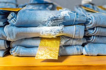 Close up of blue jeans on others with copy space; Various jeans on others with space for text