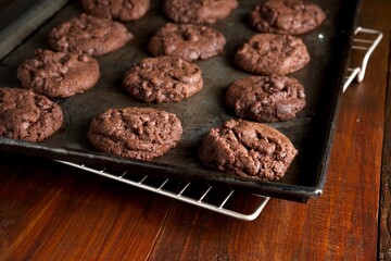 Fototapeta premium Triple chocolate chip cookies on a backing sheet