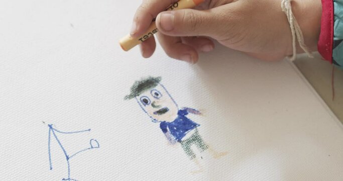 Boys are coloring cartoon characters with chalk paint. On paper for drawing inside the house.