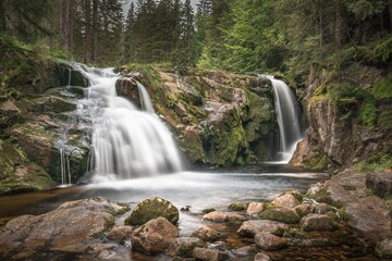 Fototapeta na wymiar The Elbe river and waterfall in the mountains of Czech Republic