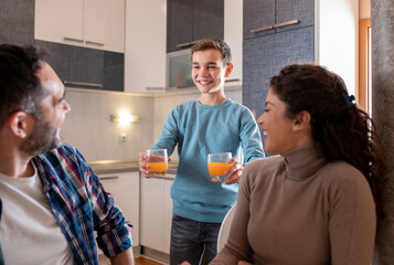 Boy holding juice for parents as surprise