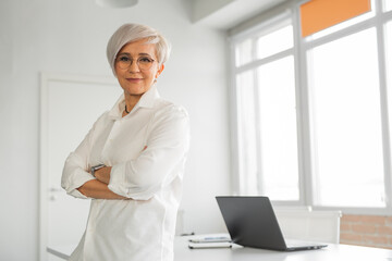 Portrait of an adult successful woman in glasses at work 