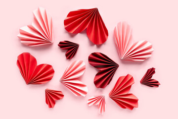 Paper hearts on pink background. Symbol of love for valentines day, happy birthday, greetings, Mothers day, Women's day. Origami.