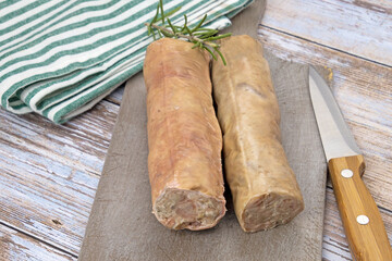 raw andouillettes de Troyes on a cutting board