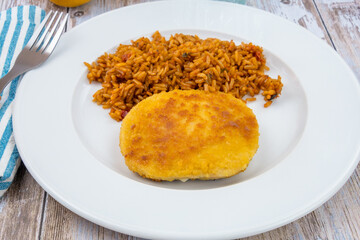 breaded meat and tomato rice on a plate