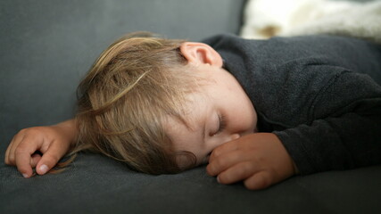 Toddler child afternoon nap on sofa close-up face asleep