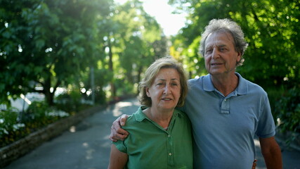Senior couple walking outside together. Older husband and wife afternoon walk