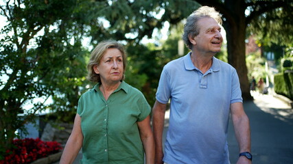 Senior couple walking outside in nature together