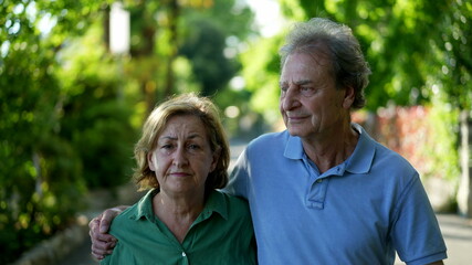Romantic older couple going for a walk, 60s senior husband and wife together