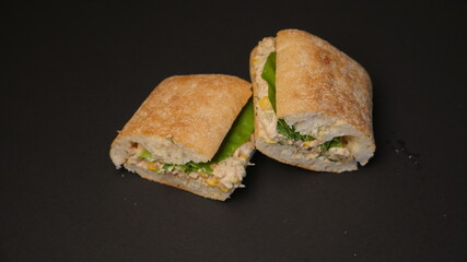 Delicious sandwich on a black background.