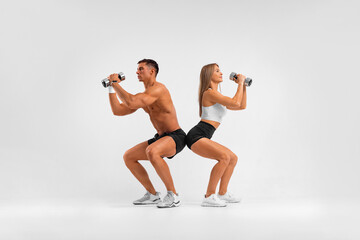 Fit couple at the gym isolated on white background. Fitness concept. Healthy life style.