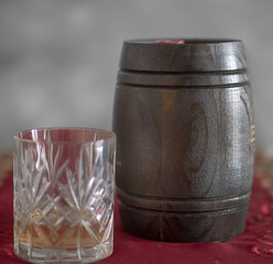 glass of whiskey aged in oak barrel