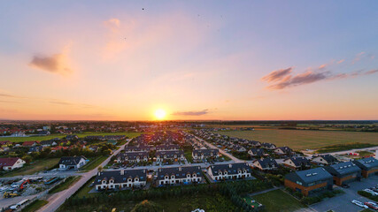 Aerial view of suburban neighborhood, Residential district with buildings and streets at small european town at sunset, panorama