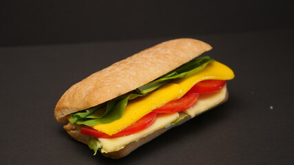 Delicious sandwich on a black background.