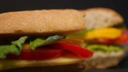 Delicious sandwich on a black background.