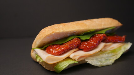 Delicious sandwich on a black background.