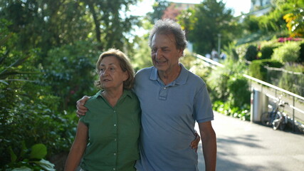 older couple walking together, senior people relationship outside in day walk