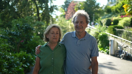 older couple walking together, senior people relationship outside in day walk